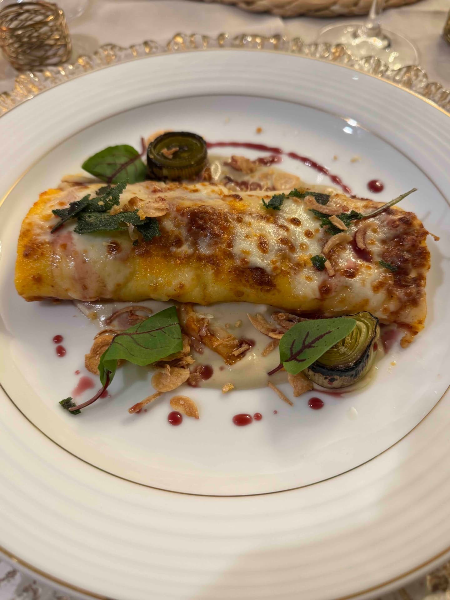 A golden cheese crêpe plated at a Luma Society dinner