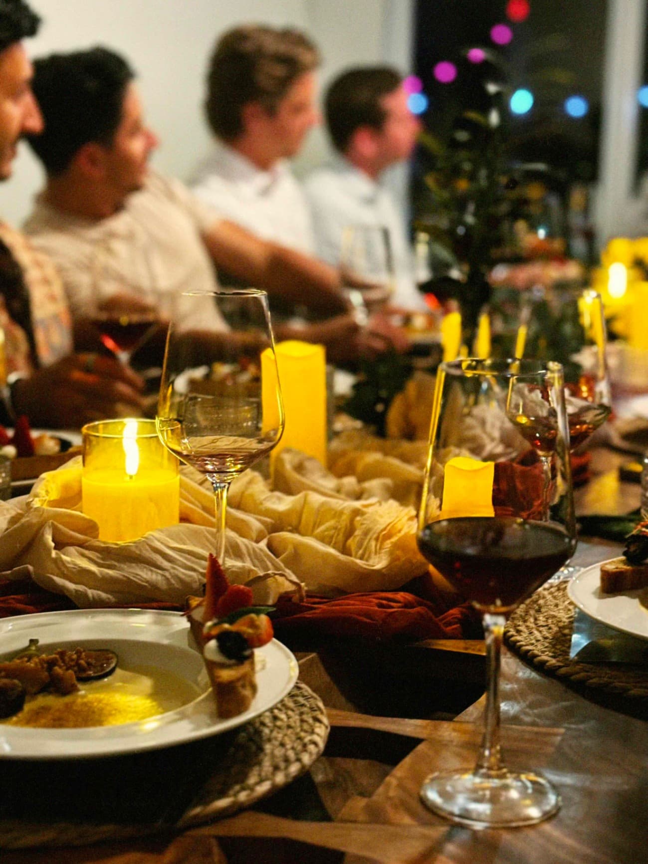 Candlelit dinner table with wine glasses at a Luma Society gathering