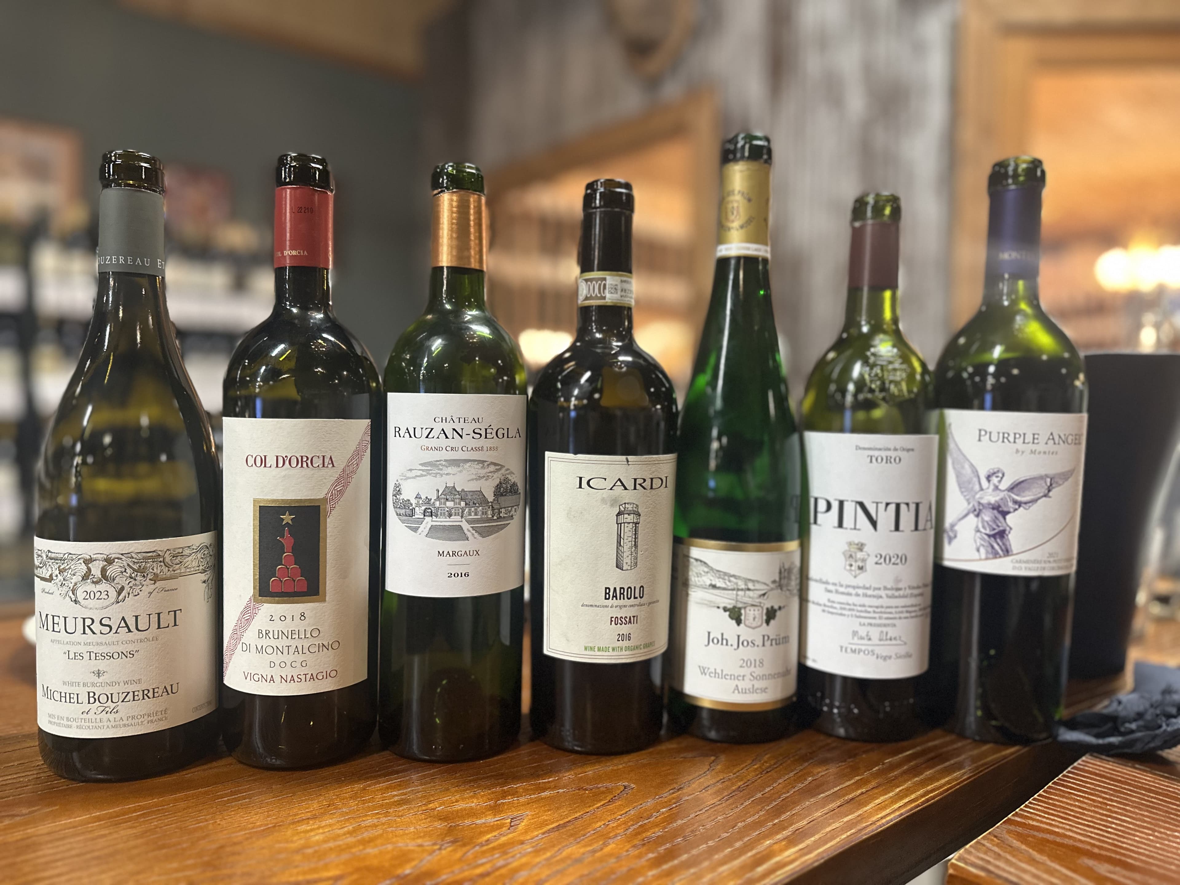 Wine bottles lined up at a Luma Society dinner